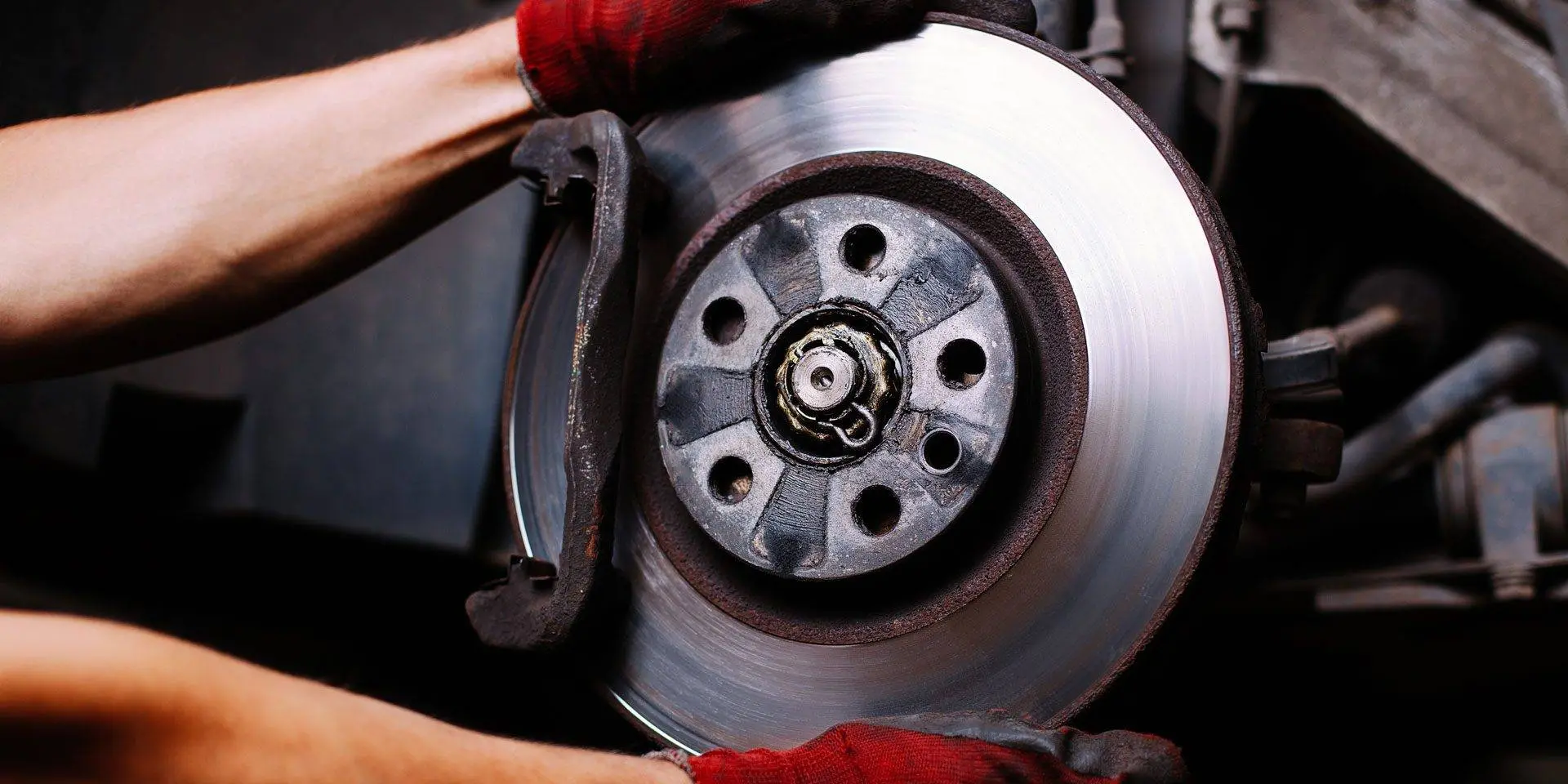 A brake rotor and pads being changed on a heavy vehicle